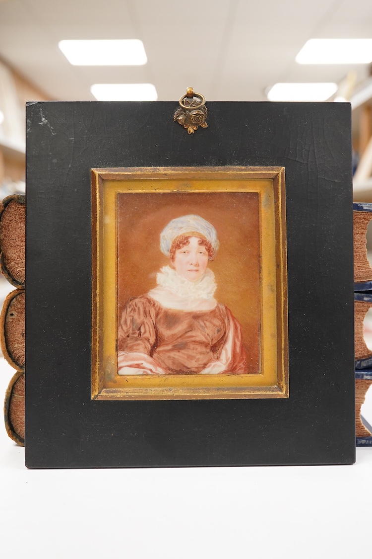 Regency School, Portrait miniature of a lady wearing a bonnet, indistinctly inscribed and dated 1822 verso, watercolour on ivory, housed in an ebonised frame, 9.5 x 7.5cm CITES Submission reference EL8U6S7D